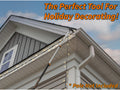Extend-A-Reach utility hook attached to a telescoping extension pole, used for Christmas light hanging along a two-story house roofline. The image displays the text “The Perfect Tool for Holiday Decorating!” and “pole sold separately.” This light hanging pole setup is ideal for hanging string lights using a telescopic extension pole or extendable pole with a utility hook for high-reach decorating.