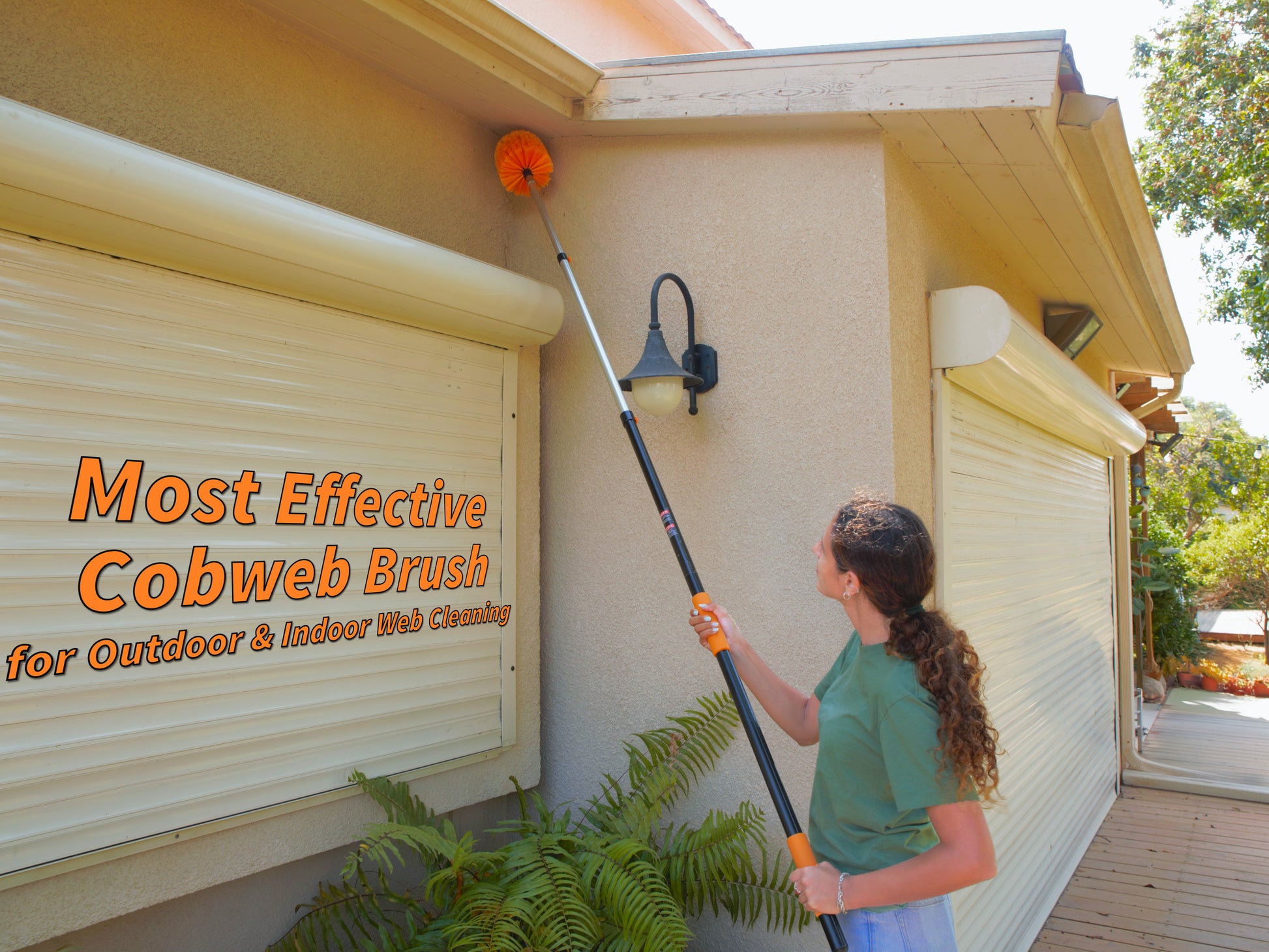 Woman using the Extend-A-Reach telescoping extension pole with bright orange cobweb duster to clean spider webs from the exterior corner of a house under the roof. Text on the image reads “Most Effective Cobweb Brush for Outdoor & Indoor Web Cleaning,” emphasizing its high reach and versatility as a spider web brush with pole