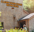 Man using Extend-A-Reach long extension pole with hard bristle scrub brush to clean high house siding. Ideal for siding, gutters, decks, and exterior walls. Text: ‘Clean Your Home With Ease’.