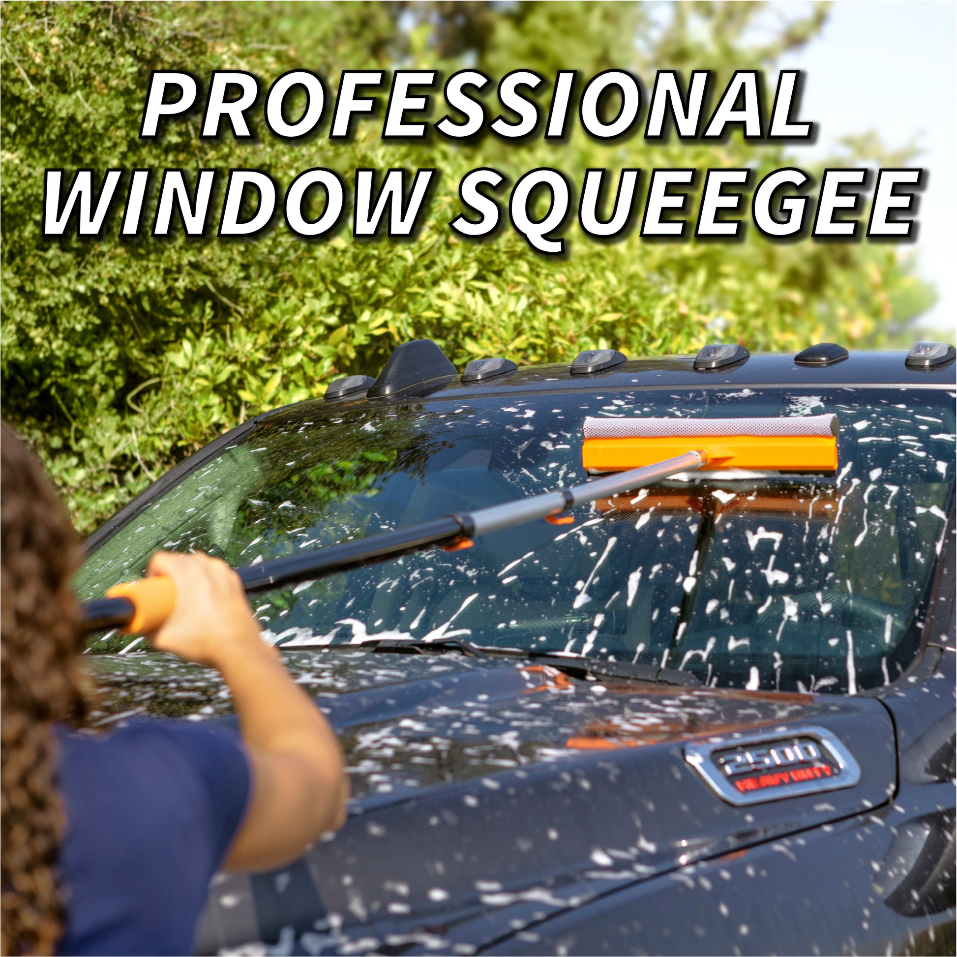 Woman using Extend-A-Reach telescoping pole with orange car window squeegee to clean soapy truck windshield. Text: ‘Streak-Free Window Squeegee’. truck cleaning.