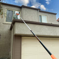 Extend-A-Reach 18 ft extension pole reaching a second-story window for safe, ladder-free high window washing