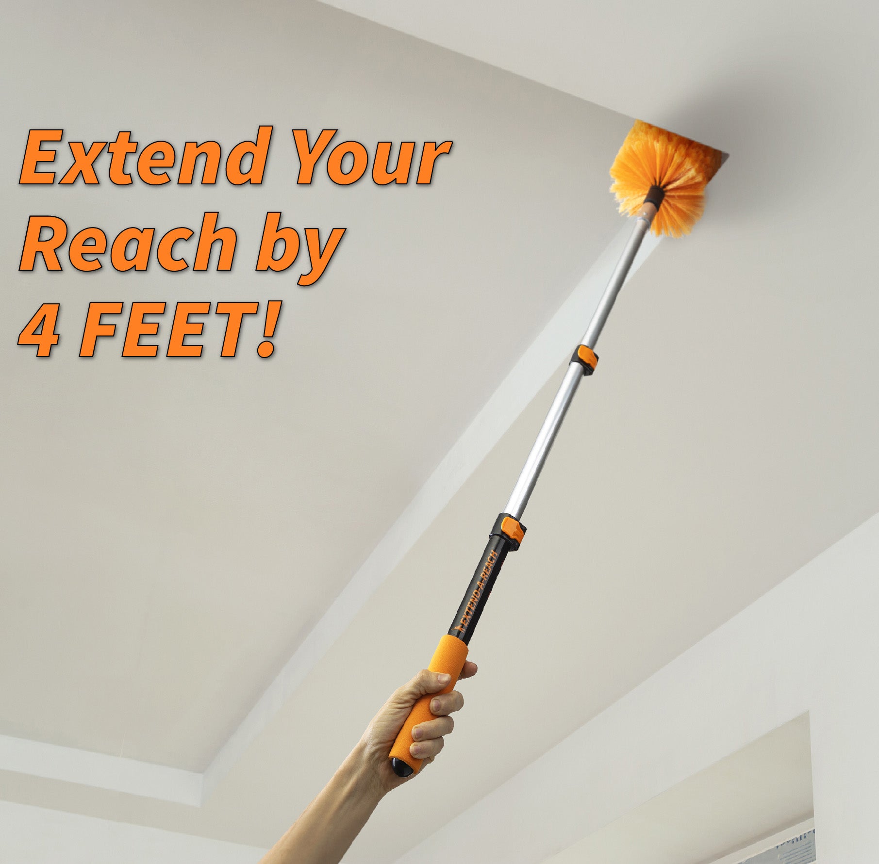 A hand holding the Extend-A-Reach dusting extension pole fully extended with a duster head, a telescoping pole designed for dusting high ceilings, removing cobwebs, and reaching high corners